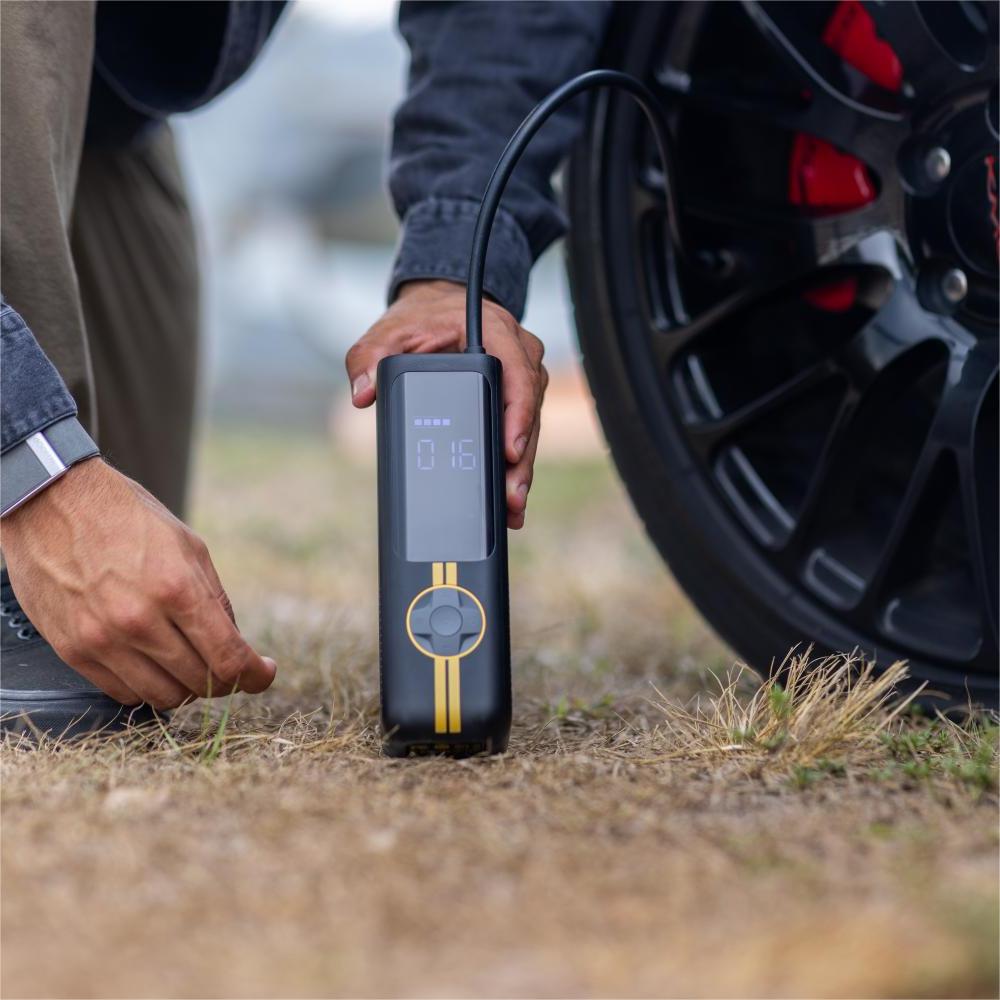 Fanttik X8 APEX tire inflator with digital display showing 016 PSI connected to car tire
