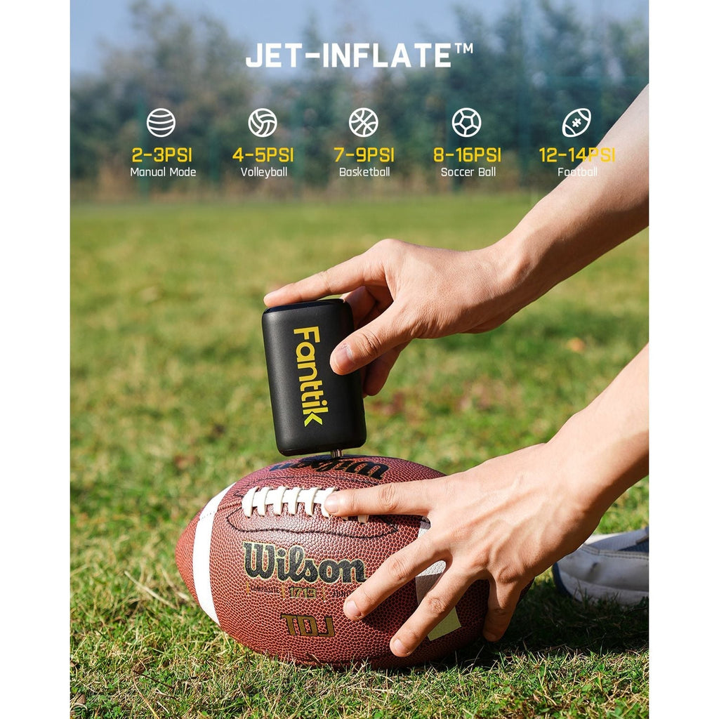 Fanttik X9 Nano electric ball pump inflating a Wilson football on grass, showing preset PSI for various sports balls.