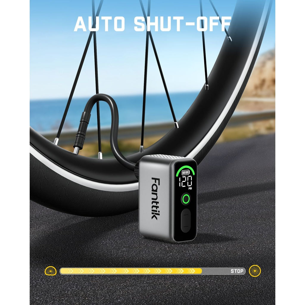 Fanttik X10 Ace tiny bike pump with digital display showing 120 PSI and auto shut-off feature near a bicycle wheel.