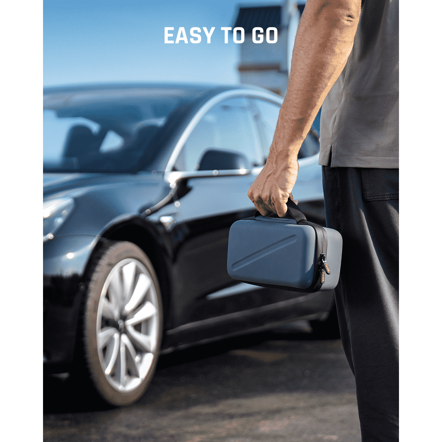 Fanttik EVA protection case for X8 APEX tire inflator with 'EASY TO GO' text, held by a person near a car.