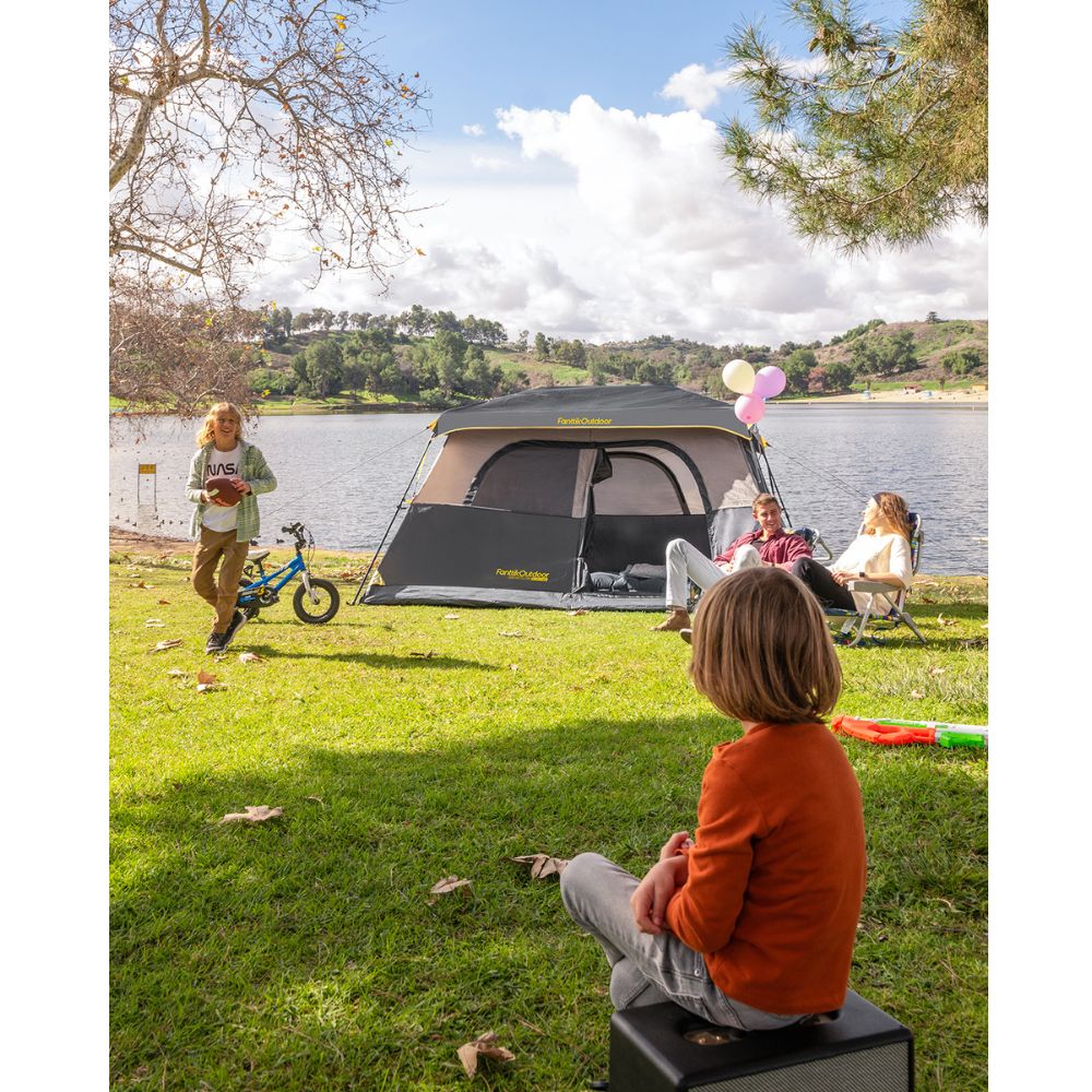 FanttikOutdoor Zeta C6 Pro Max 6 person camping tent set up by a lake with a family enjoying the outdoors.