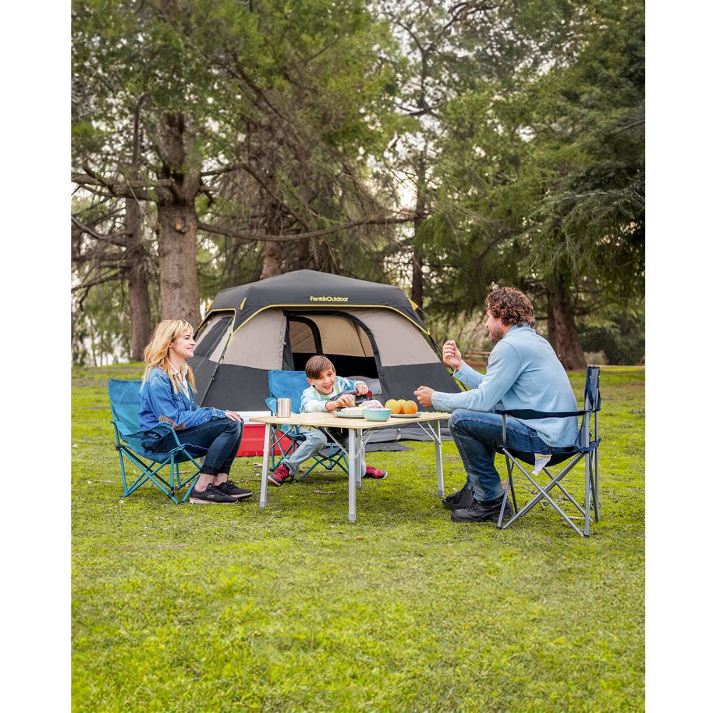 Family enjoying a meal at a picnic table outside a FanttikOutdoor 6-person cabin tent.