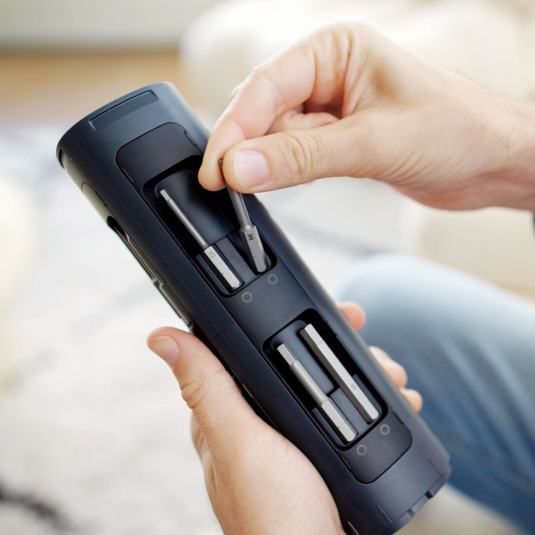 Fanttik S1 Pro cordless electric screwdriver case with person inserting H4 bit.