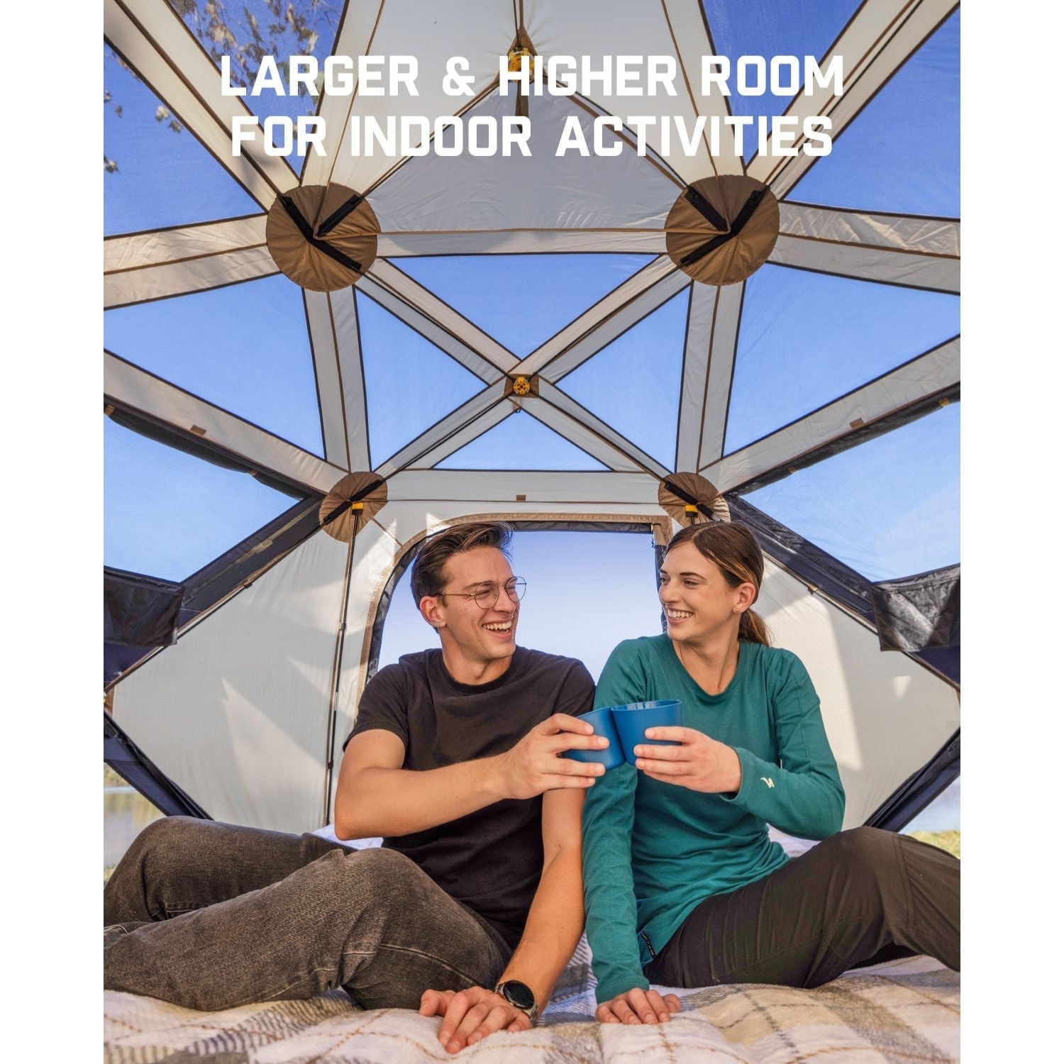 Couple enjoying drinks inside FanttikOutdoor Alpha C6 Ultra tent, showcasing spacious interior for activities.