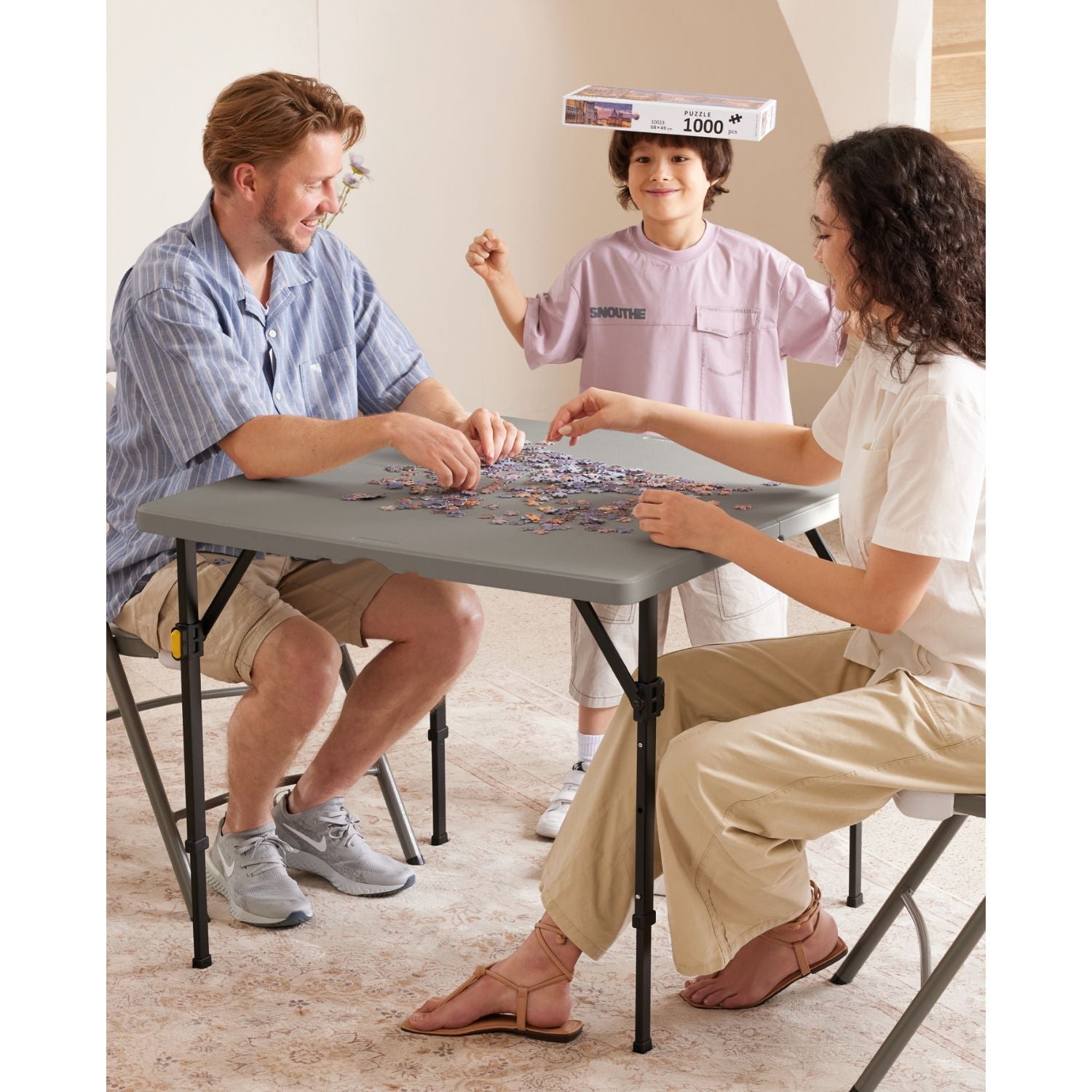 Family completing a 1000-piece puzzle on a FanttikOutdoor Zeta S4 Pro 34" square folding table.