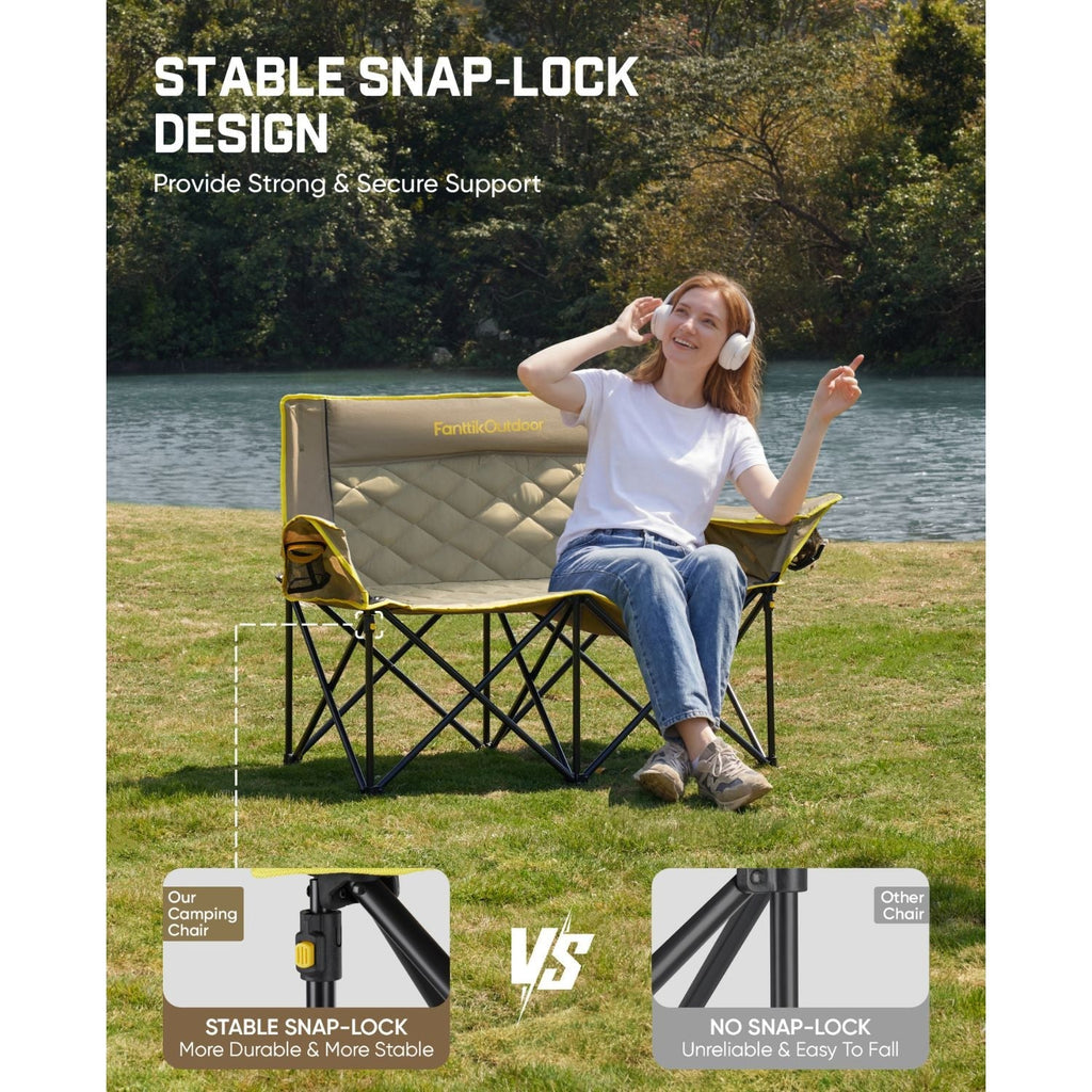 Double camping chair with stable snap-lock frame, yellow trim, and quilted beige seat by the lake
