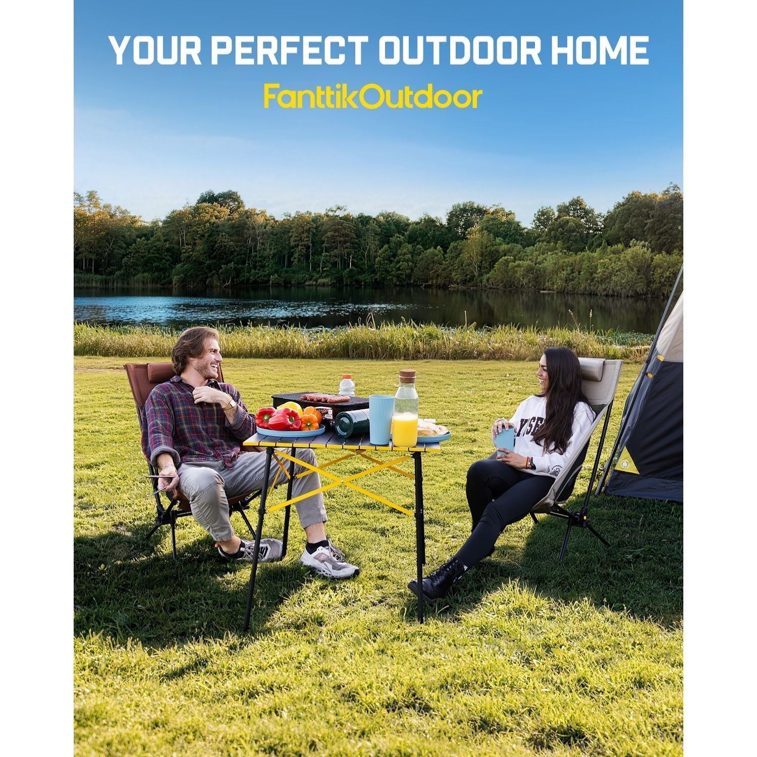 FanttikOutdoor camping table with foldable X-frame beside two campers at a lakeside picnic