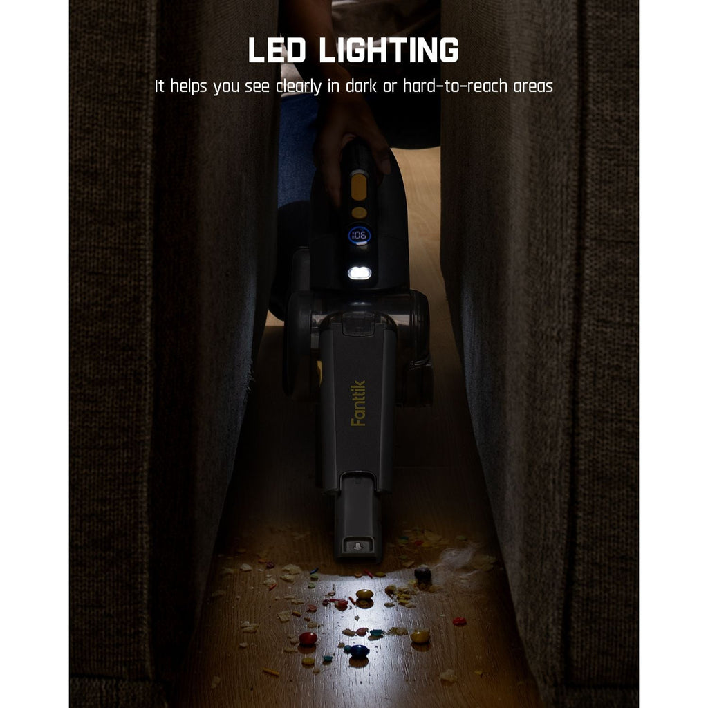Fanttik Fold V10 Ultra handheld vacuum with LED lighting cleaning debris in a dark, narrow space.