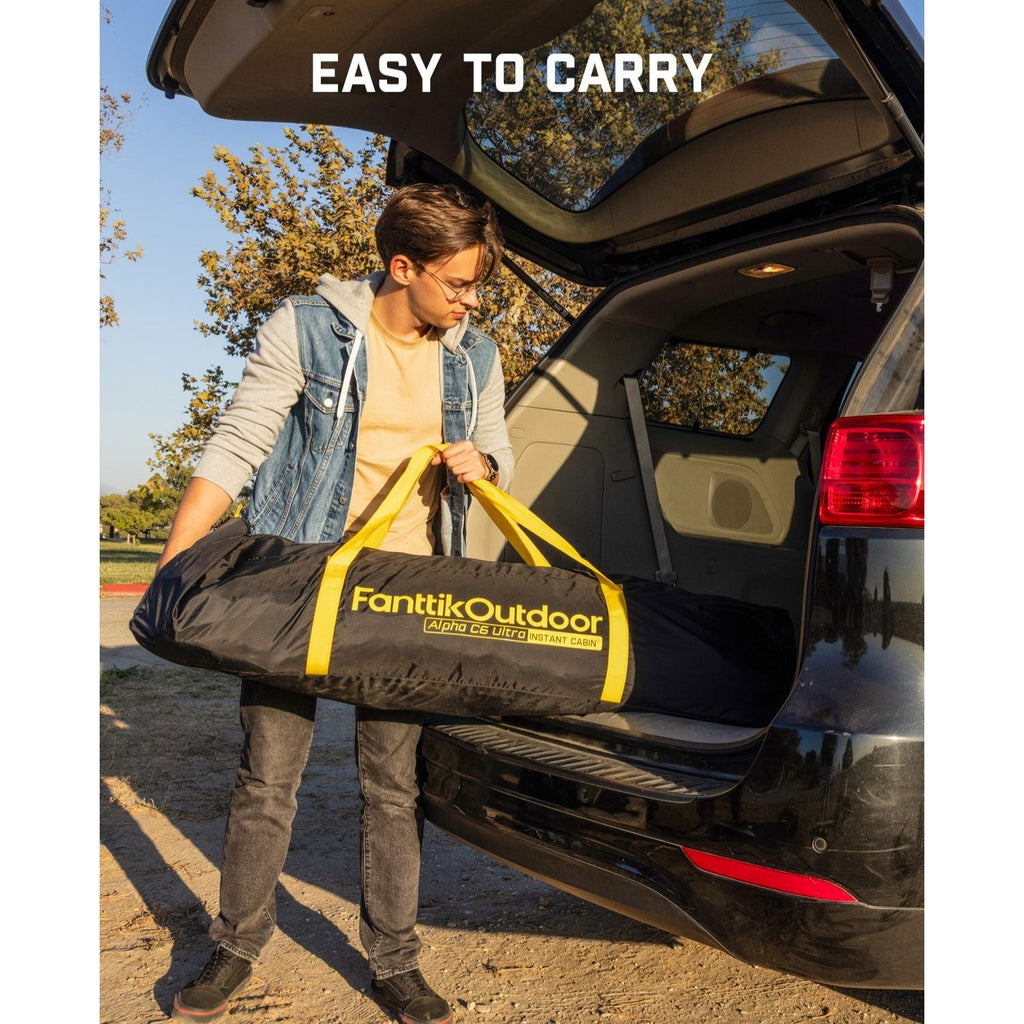 Young man loading FanttikOutdoor Alpha C6 Ultra Instant Cabin tent bag into car trunk for easy carrying.