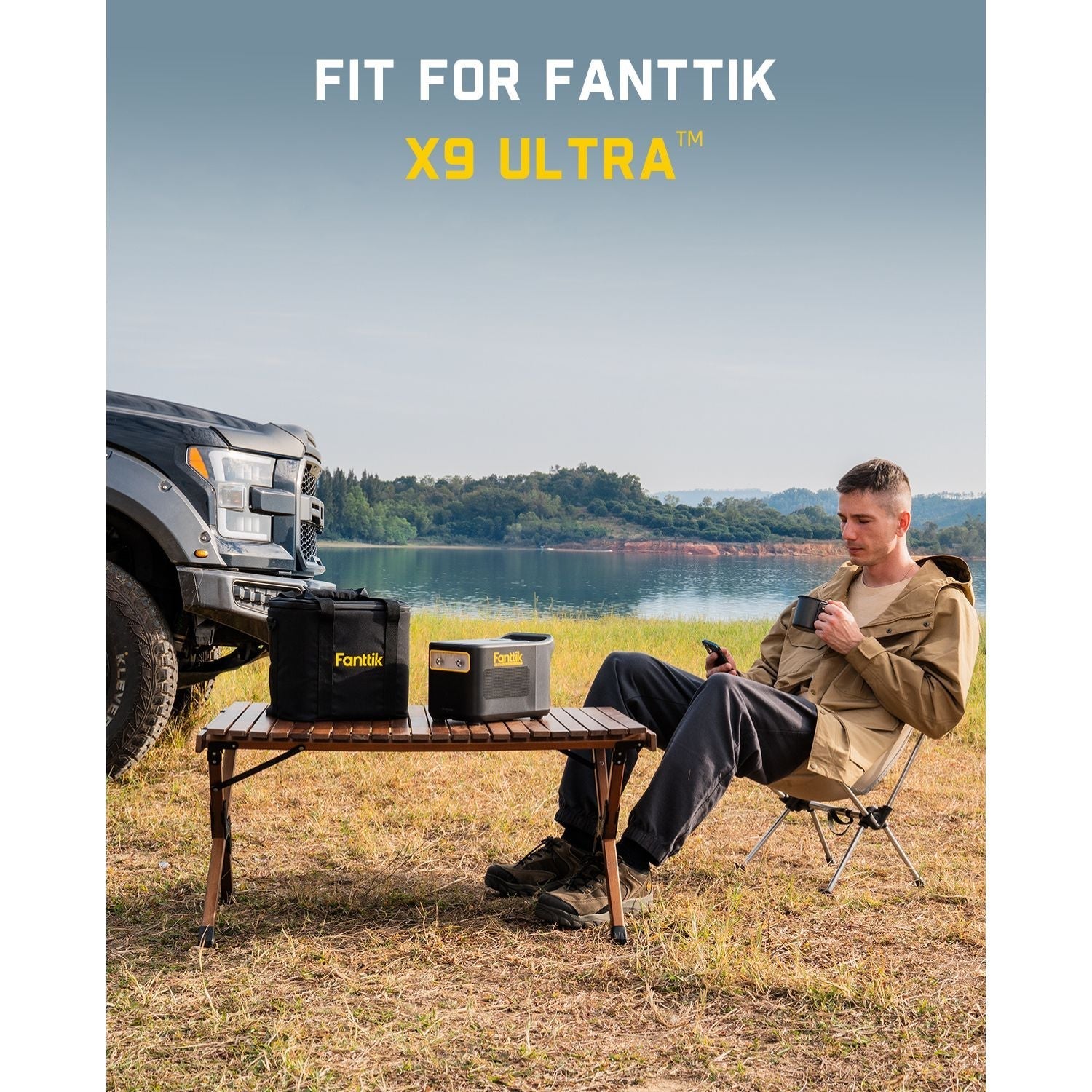 Fanttik carrying bag for X9 Ultra tire inflator, black fabric with yellow logo, on a wooden table outdoors.