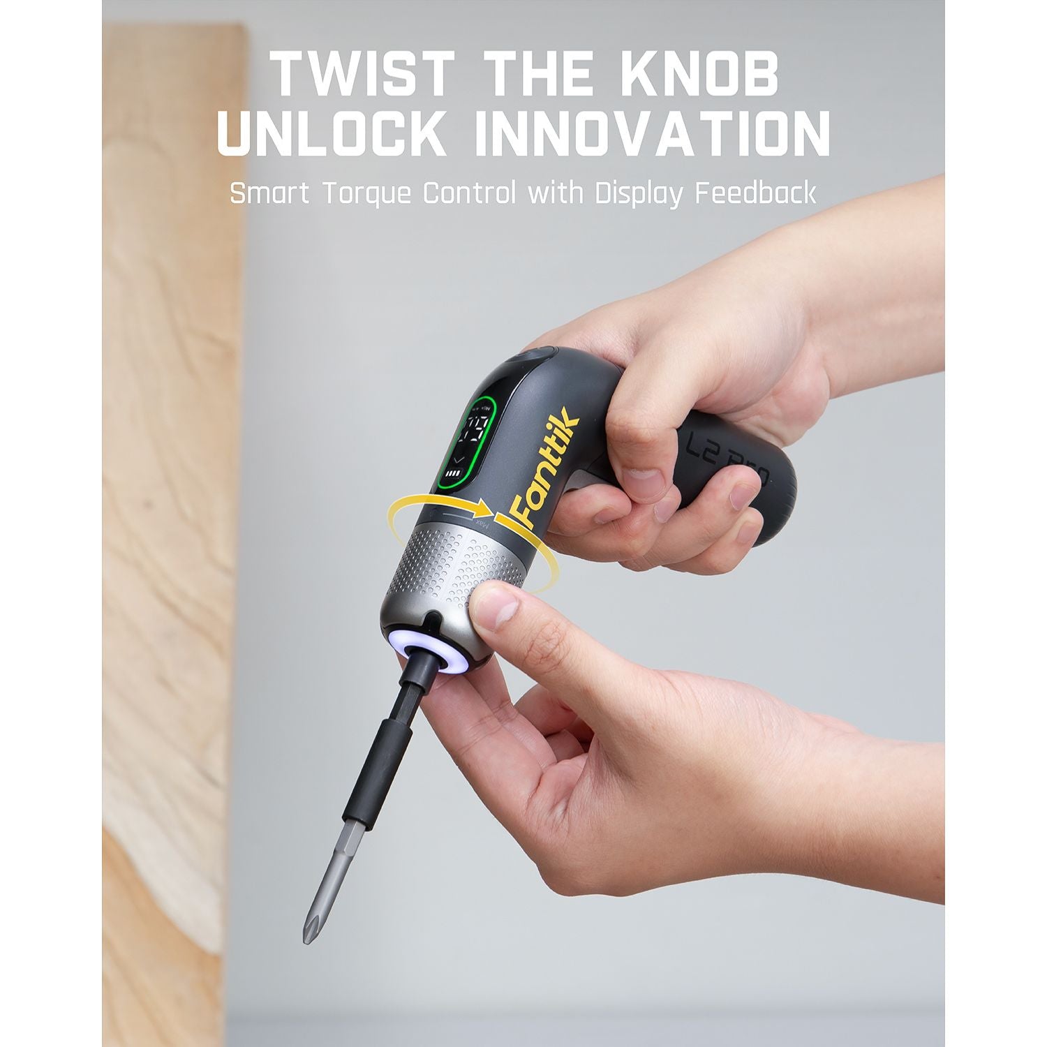 Fanttik L2 Pro cordless electric screwdriver with smart torque control and display feedback, held by hands.