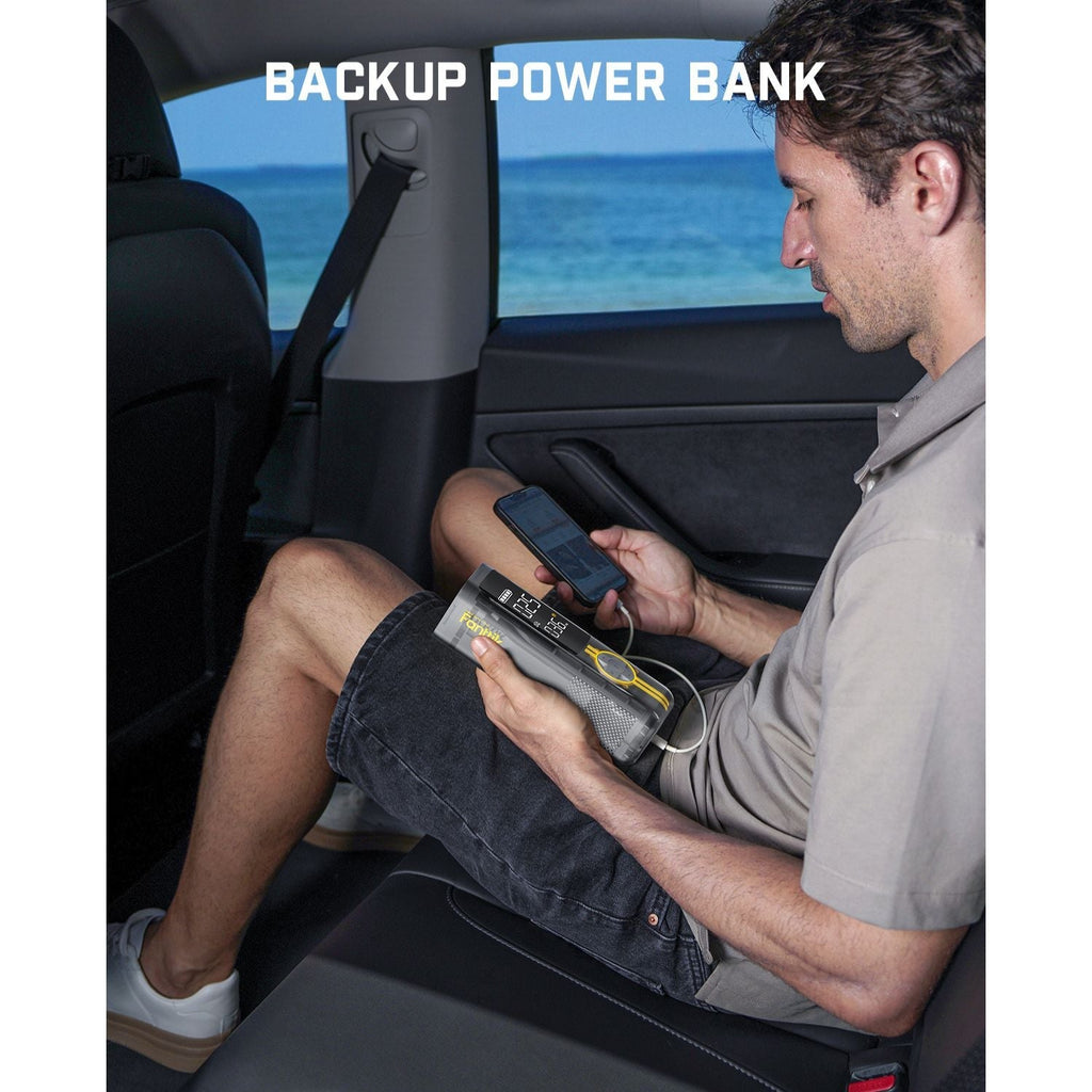 Fanttik X8 APEX tire inflator charging a phone, serving as a backup power bank in a car.