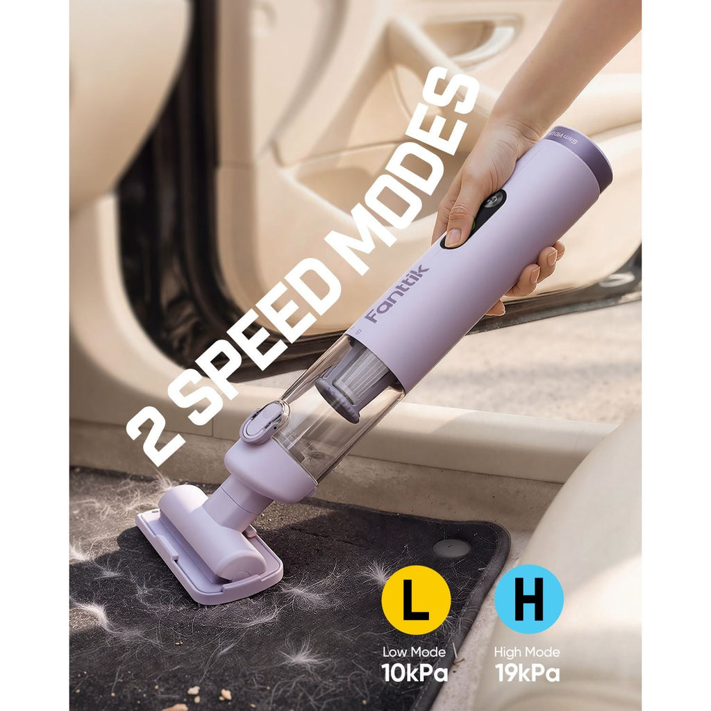 Handheld vacuum cleaner being used to clean a car floor with '2 Speed Modes' text displayed.