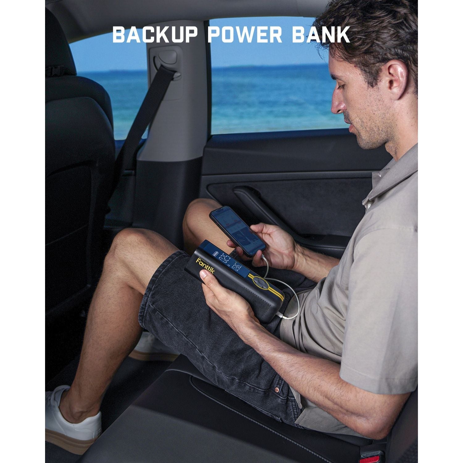Fanttik X8 APEX tire inflator serving as a backup power bank for a smartphone inside a car.