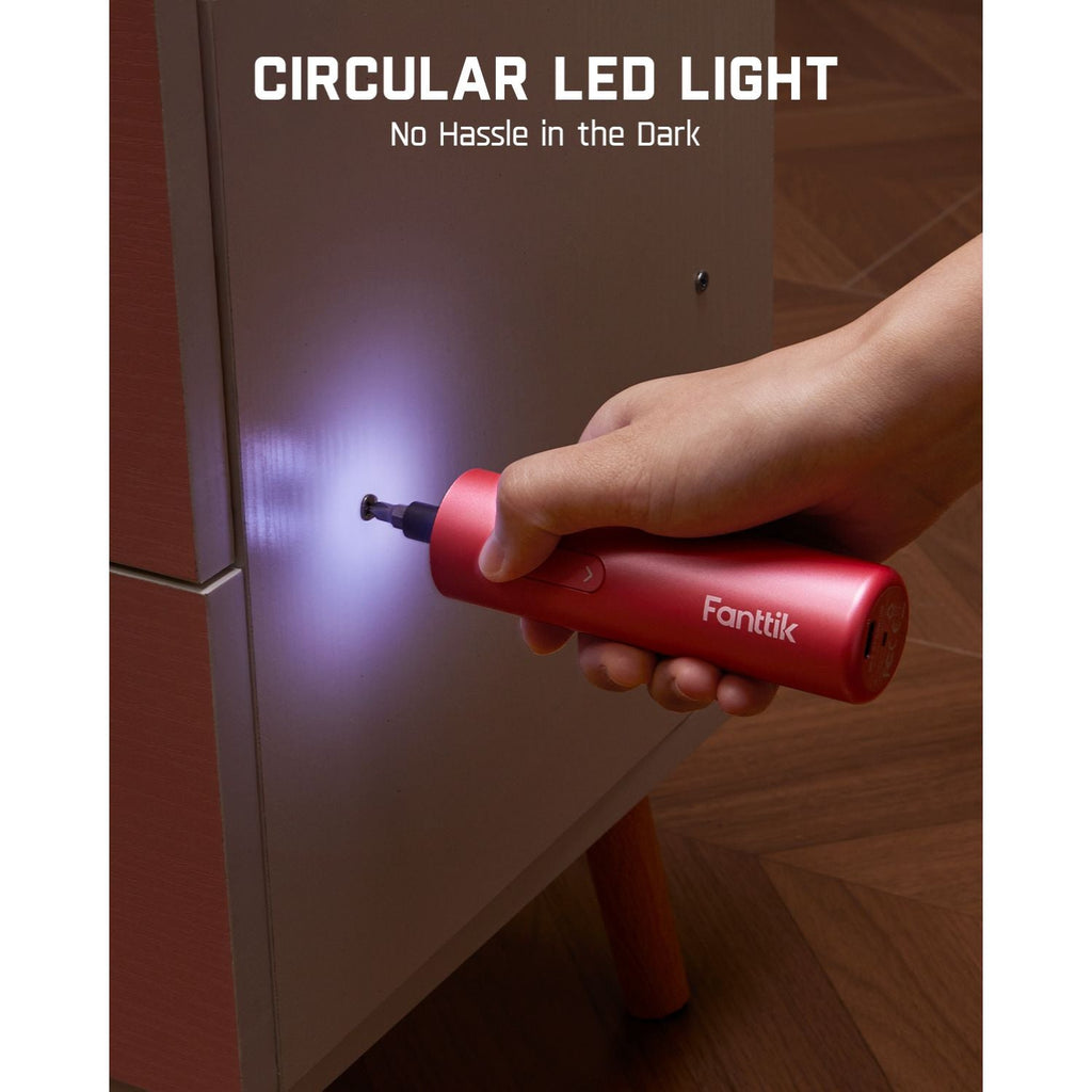 Red Fanttik S1 Capsule cordless screwdriver with circular LED light illuminating a dark cabinet.