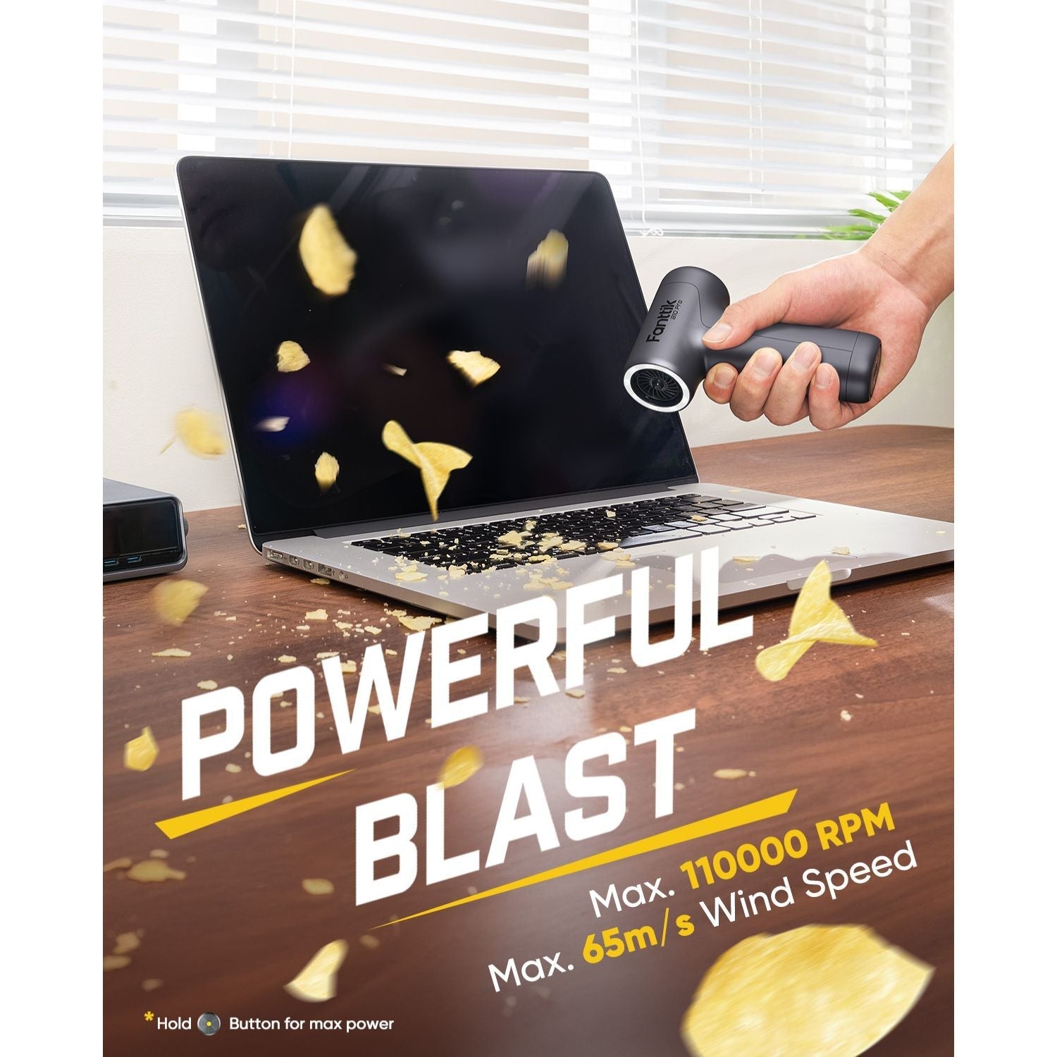 Fanttik B10 Pro electric air duster blowing debris off a laptop keyboard, max 110000 RPM