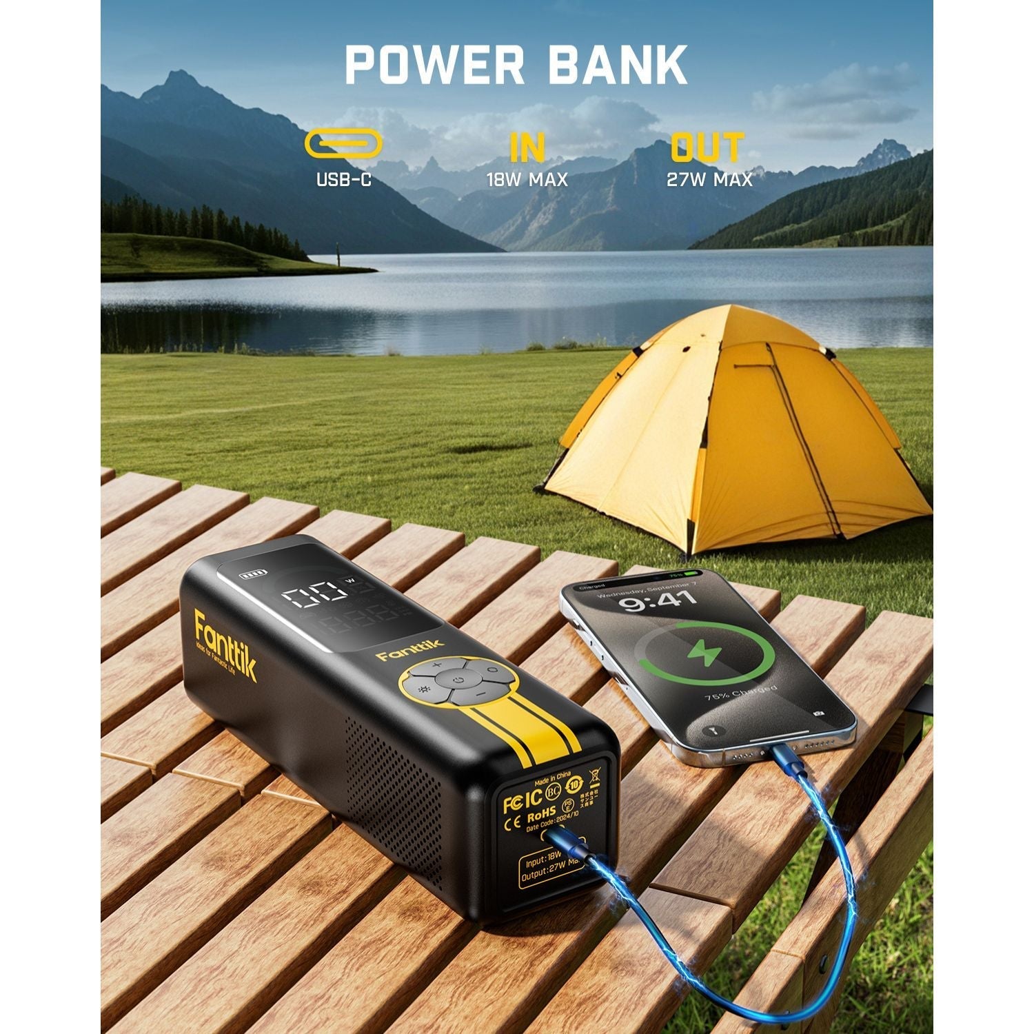 Fanttik X10 Cross tire inflator charging a phone, showing power bank functionality. Outdoor scene with tent and lake.