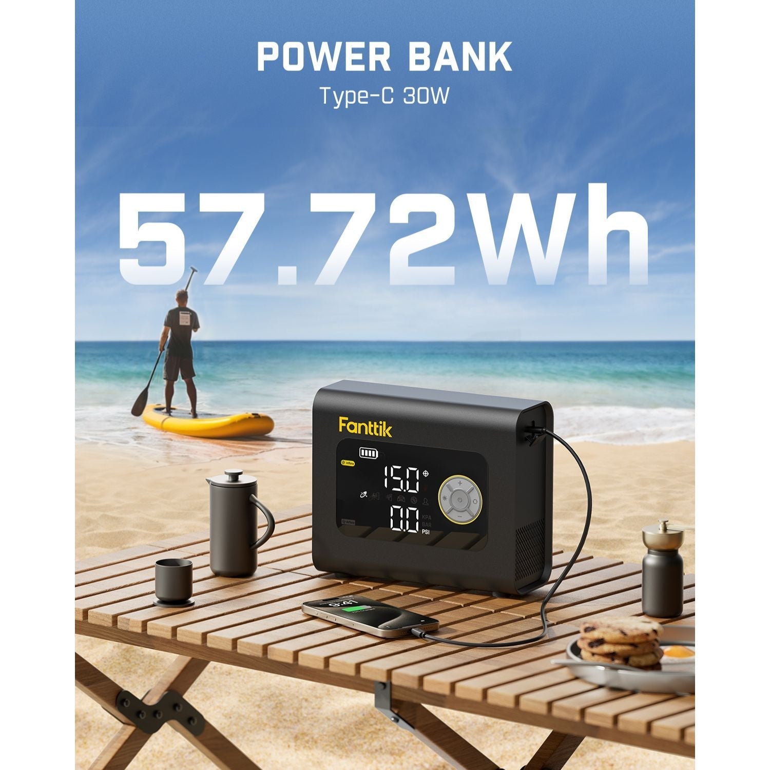 Fanttik X9 Cross paddle board air pump power bank with 57.72Wh capacity on a beach table, charging a phone.