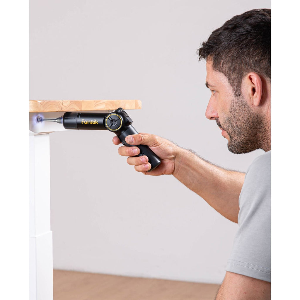 Man using Fanttik Fold S1 APEX cordless screwdriver with LED light for precision screw insertion.